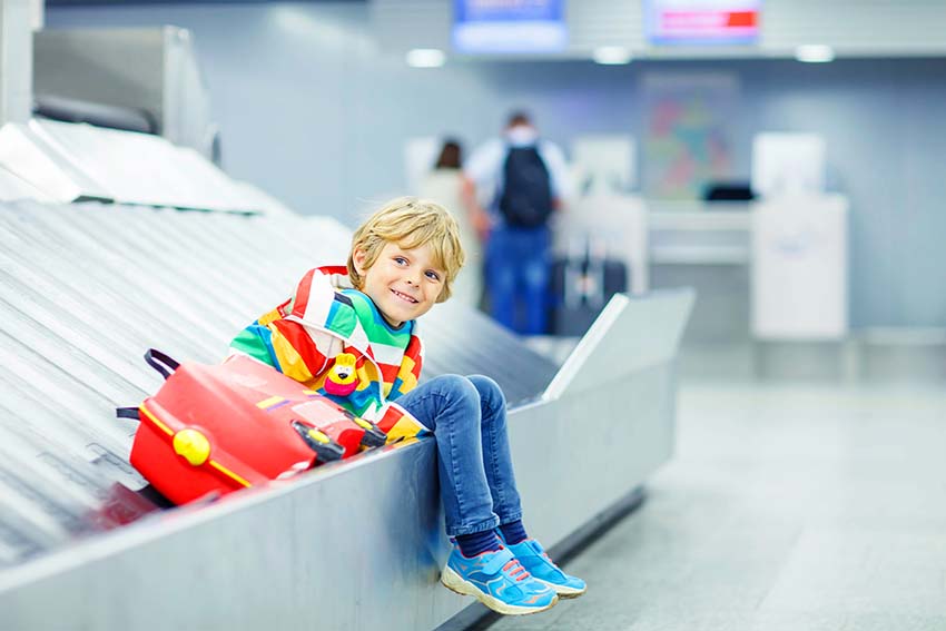Child Waiting For Parents at Airport Baggage Claim