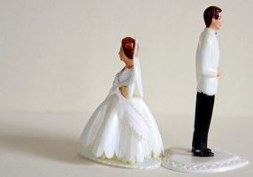 Vintage plastic bride and groom separated by strife