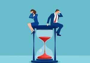 Vector of a stressed businessman and businesswoman sitting on a hourglass